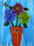 Terra cotta flower pot with shattered glass and wooden butterflies